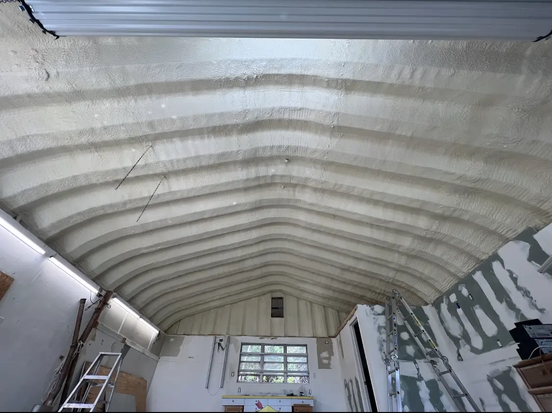 Spray polyurethane foam applied to the underside of a metal roof deck in Iona